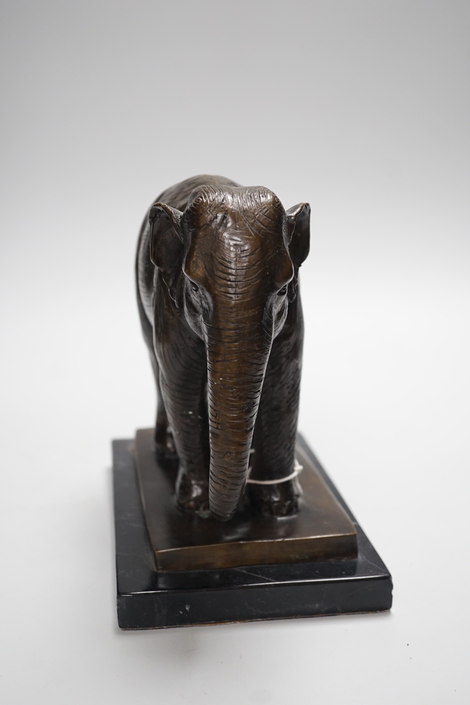 A bronze elephant, on black marble plinth, unsigned, 20cms high